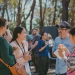 Adults in conversation during a session break (thumbnail)