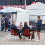 Delegates around the campfire waiting for the evening session (thumbnail)