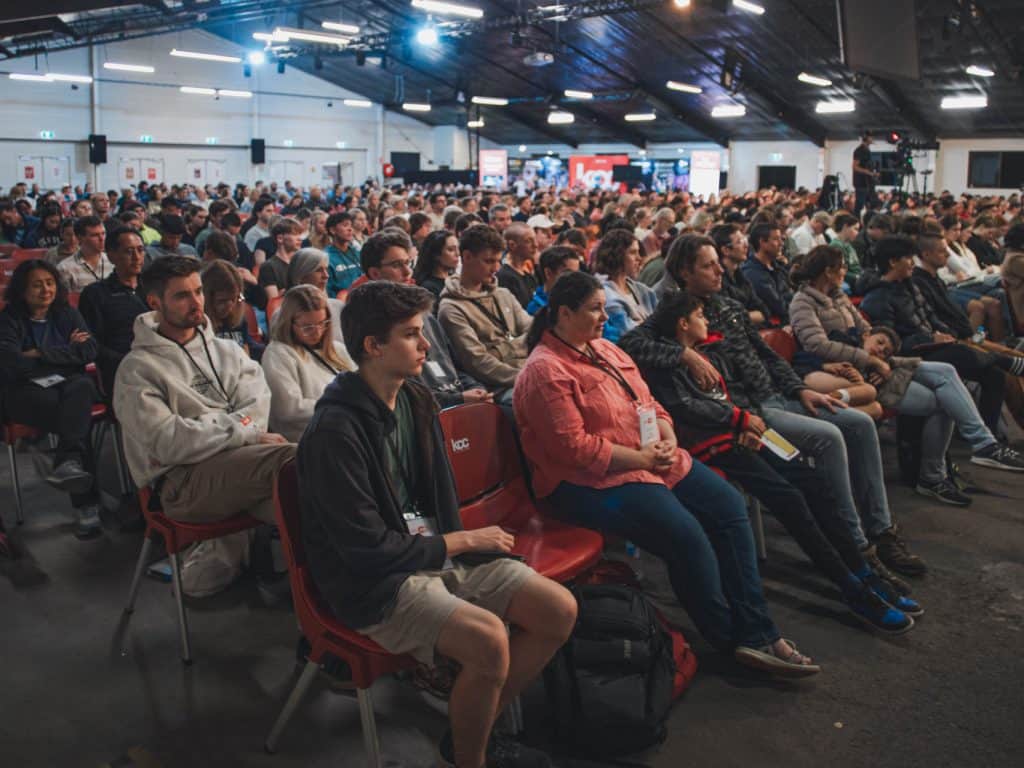 Attendees at the Katoomba Easter Convention in a large indoor venue.